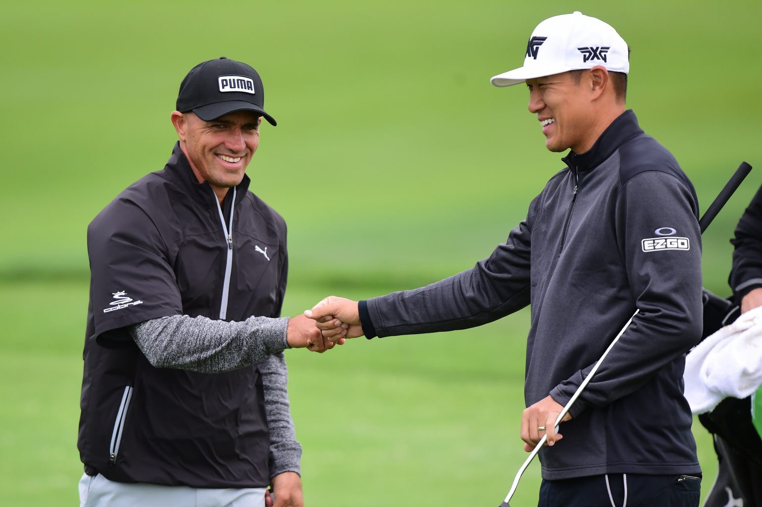 Kelly Slater and James Hahn exchange a fist pump