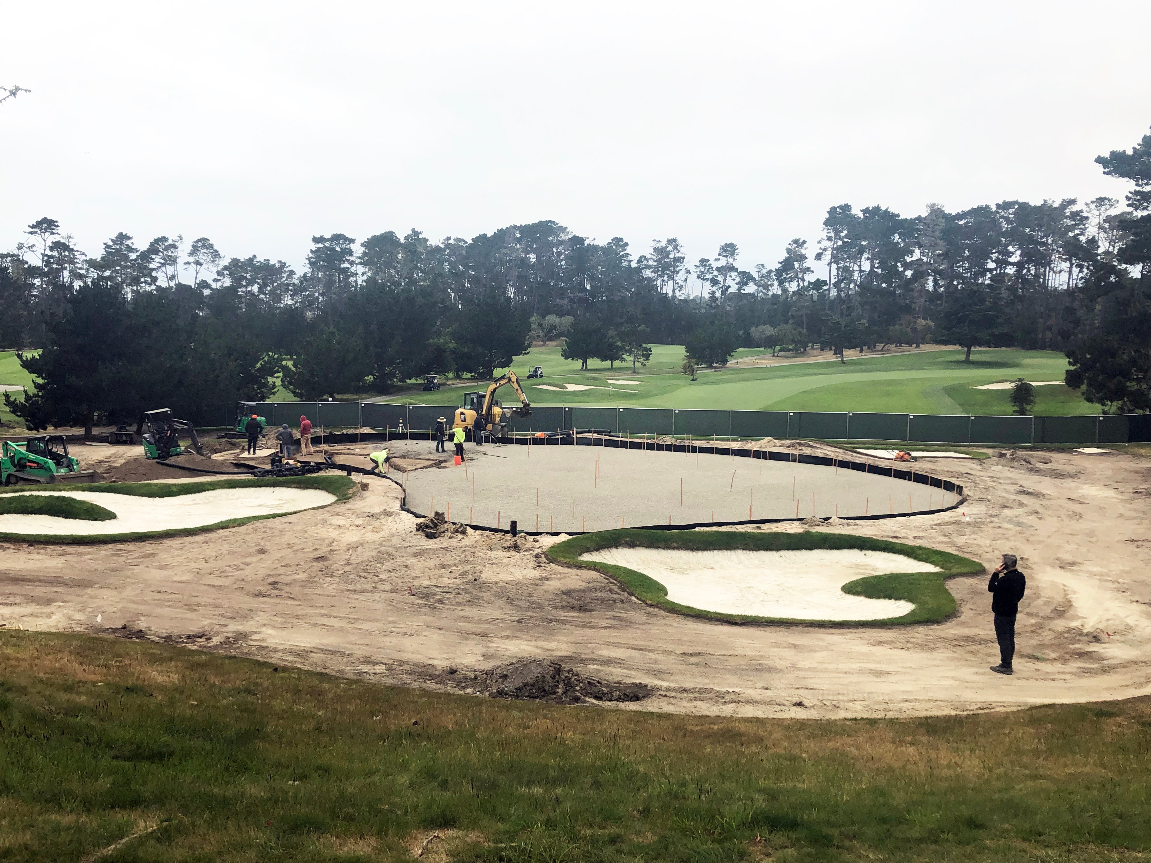 Renovation crew lays down a layer of gravel during spyglass hill 17th green renovation on a foggy day