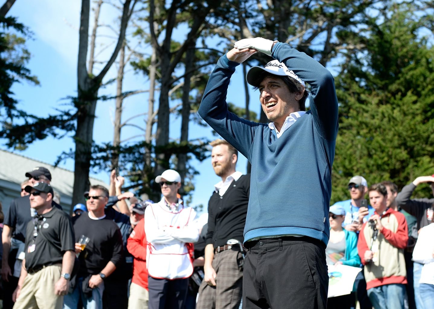 Actor Ray Romano standing with a crowd on a golf course