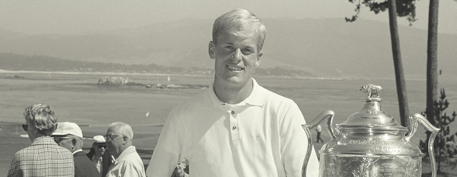 Johnny Miller stands with trophy, black and white photo