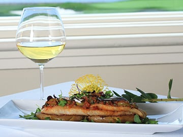 Salmon dish and glass of wine 