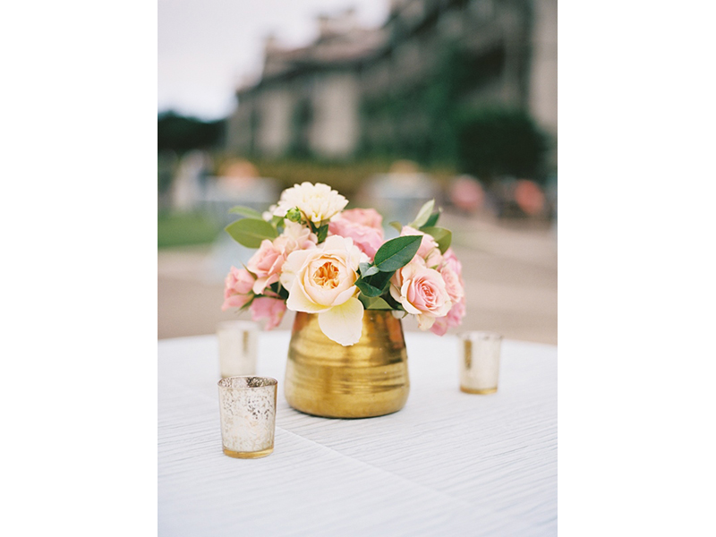 Small floral arrangement in gold vase