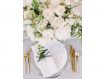 Wedding table setting with gold flatware and flowers