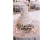 Four tiered wedding cake with serving set
