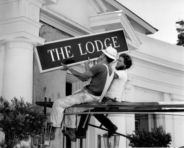 Men putting up The Lodge sign at Pebble Beach