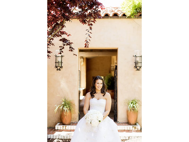 Bride sitting at Casa Palmero holding bouquet