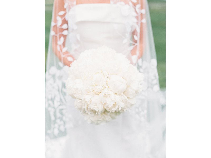 Bride holding bouquet of white flowers