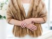 Close up of bride's torso and arms wearing fur stole