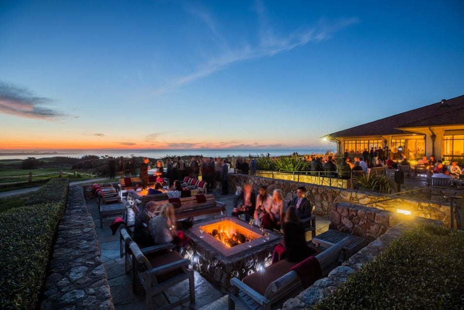 guests gathered around the spanish bay fire pits at dusk