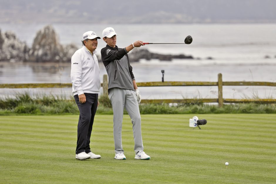 Pro and Junior Golfer on 18th tee