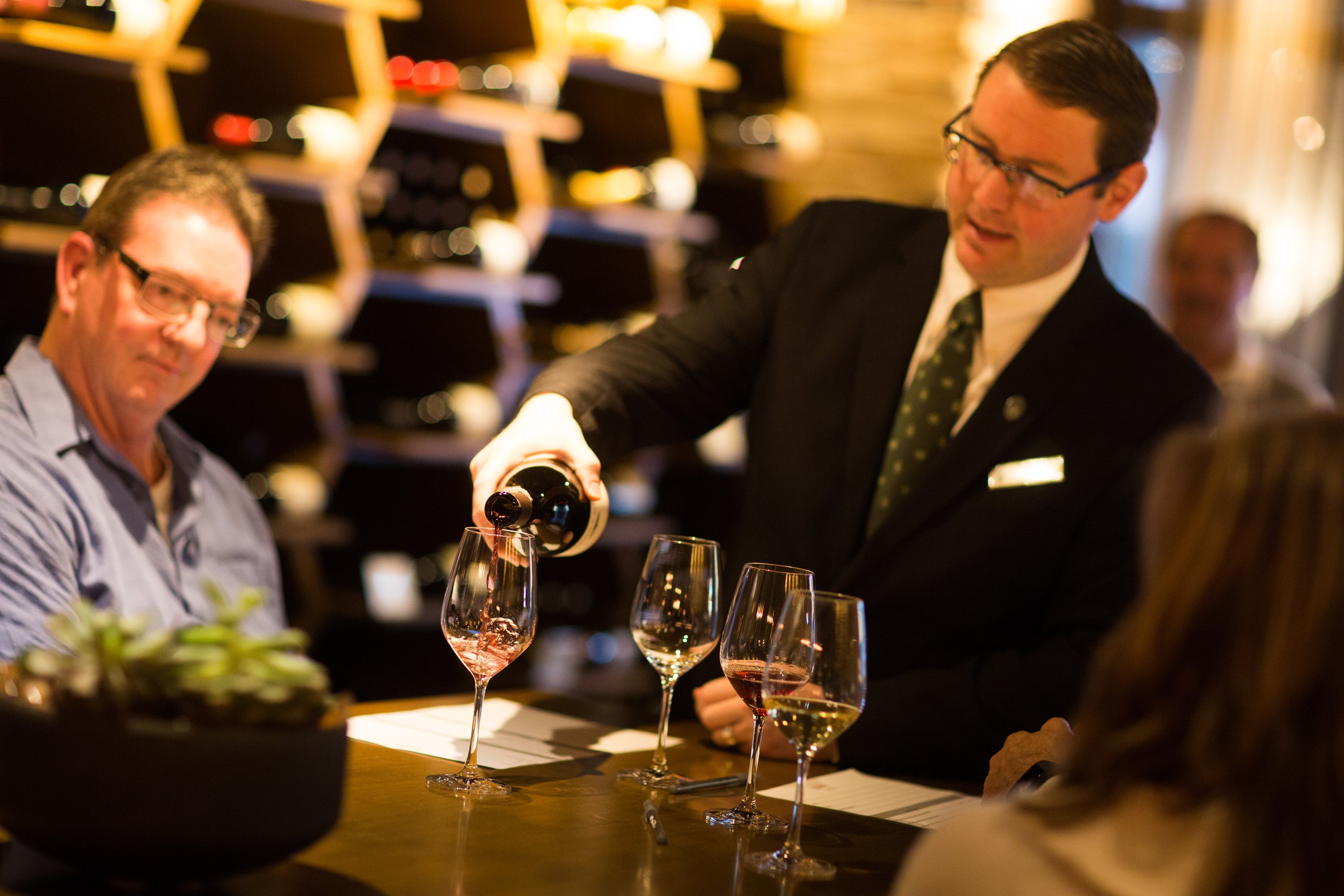 Jeff Birkemeier pours a glass of red wine for a guest at Stave Wine Cellar