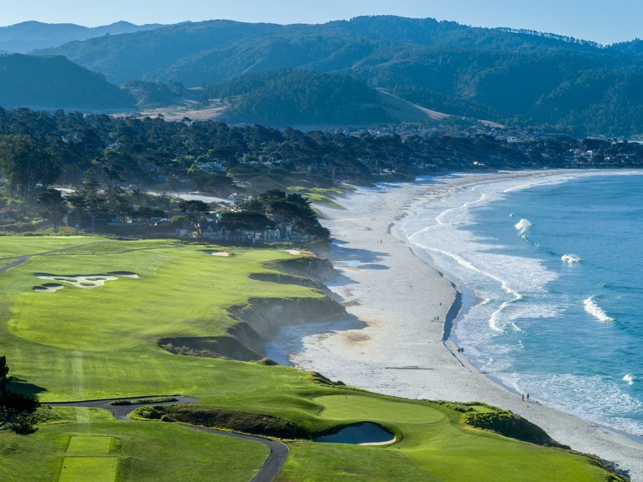 Aerial view of pebble beach golf links ninth and tenth holes with carmel beach and mountains in the background