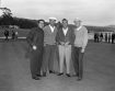 Arnold Palmer standing with 3 other men on a golf course at Pebble Beach