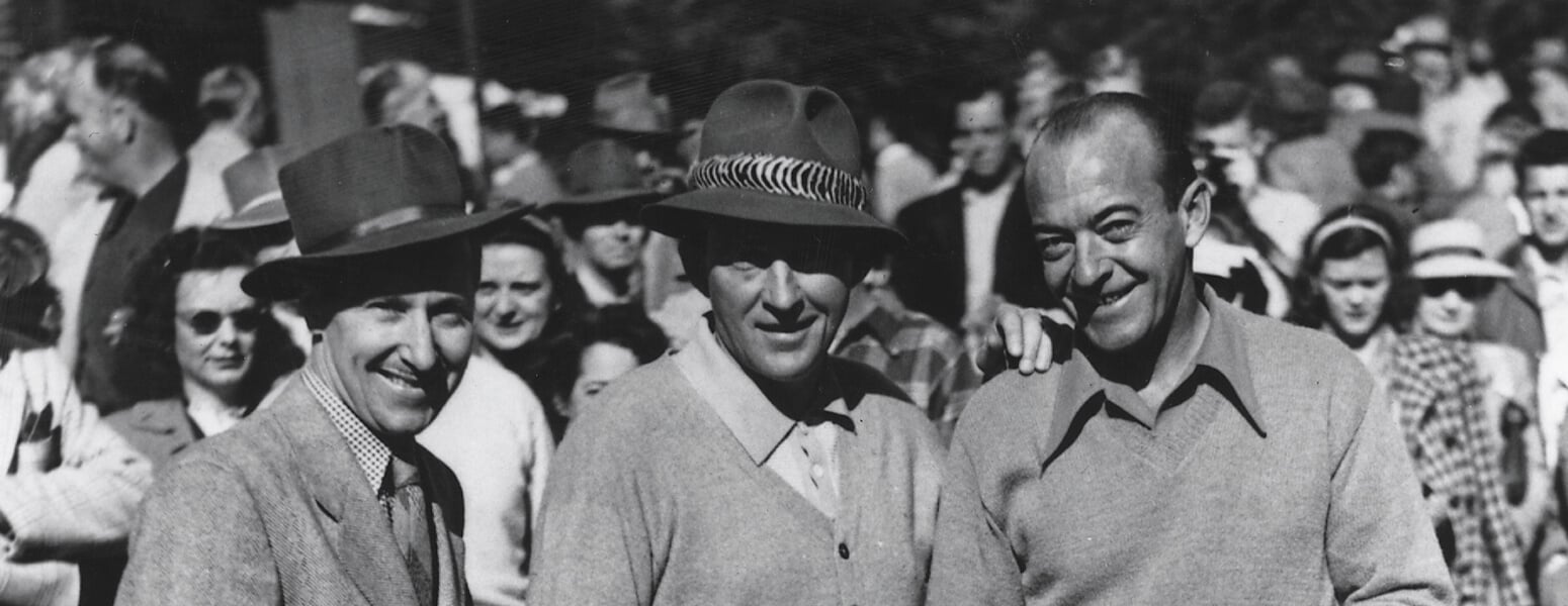 black and white photo of three men smiling on golf course