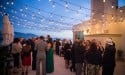 Wedding guest outside on the patio at dusk